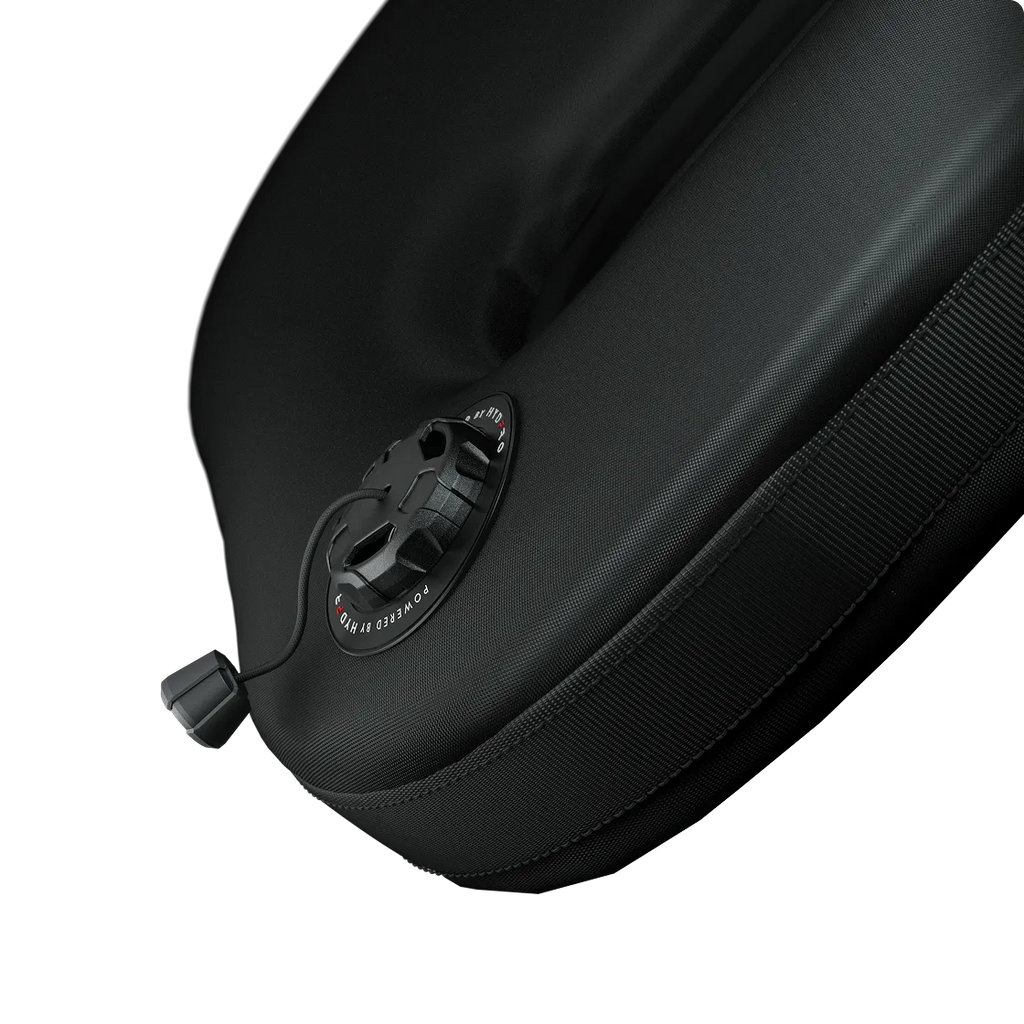 Angled view of the OPV T02 installed at the bladder corner, hose barb and ribbed seam visible